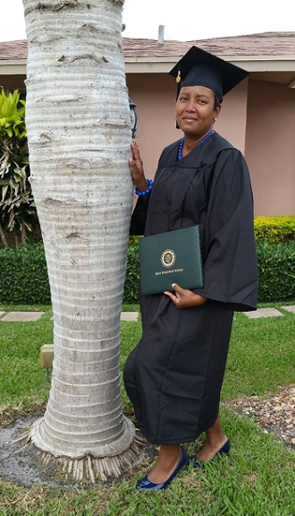 Laconia Butler poses with her degree in early education education