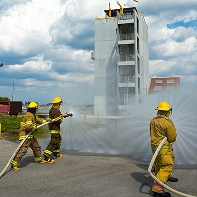 Students in the Fire Acdemy using the water hose